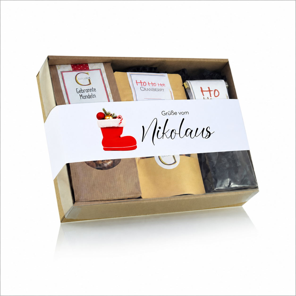 Grüße vom Nikolaus Geschenktüte von Genial Genießen mit winterlichen Spezialitäten wie Tee, Fruchtgummi, Pflaumenlikör und Marshmallows in einer festlichen Kraftpapiertüte.
