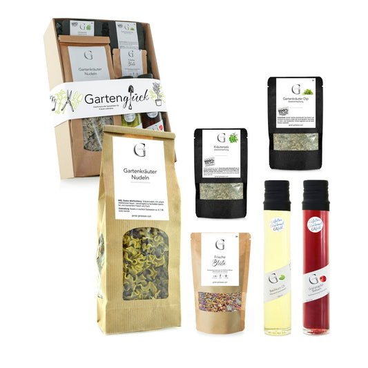 Hochwertige Geschenkbox Gartenglück von Genial Genießen mit feinen Gartenkräuter-Produkten wie Öl, Essig-Crema, Gewürzen, Nudeln und Tee für frische und kreative Küche.