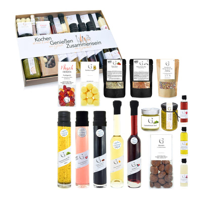 Hochwertiges Genial Genießen Geschenkset mit feinen Zutaten zum Kochen und Verfeinern von Speisen, stilvoll zusammengestellt als Geschenk für Genießer und gemeinsame Mahlzeiten.