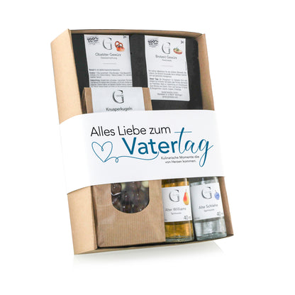 Dekoratives Vatertagsgeschenk von Genial Genießen mit ausgewählten Genussprodukten, darunter edle Getränke, süße Snacks und Feinkost für einen besonderen Anlass.
