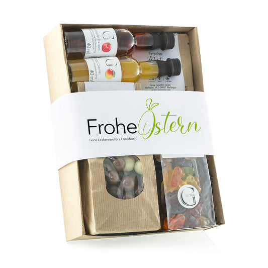 Oster-Geschenkbox mit Fruchtgummis, Kräutertee, Schokoladen-Knusperkugeln sowie fruchtigem Balsam und Mango Crema.